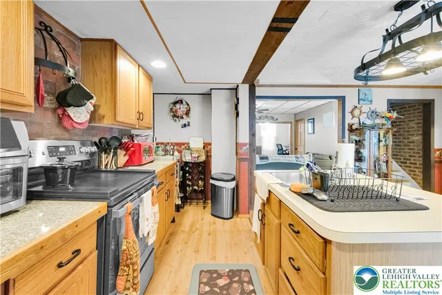 a kitchen with a sink and living room