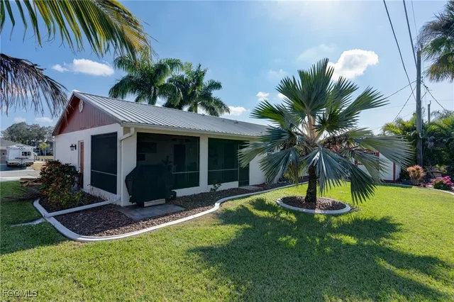 a view of a house with a yard and a patio