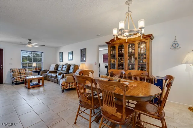 a view of a dining room with furniture and chandelier
