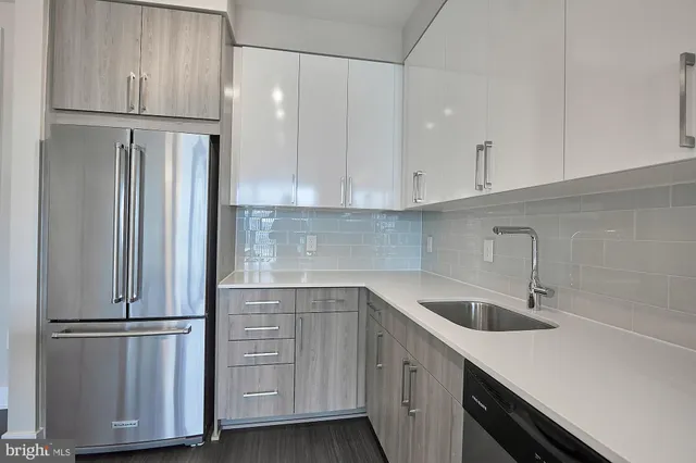 a kitchen with cabinets and a refrigerator