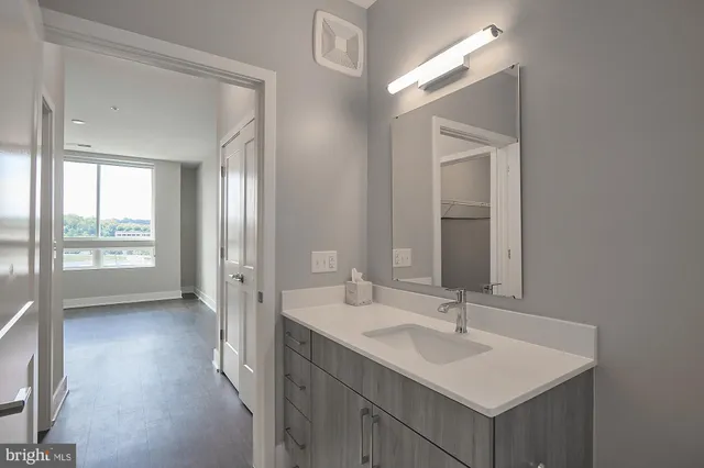 a bathroom with a sink a mirror and a vanity