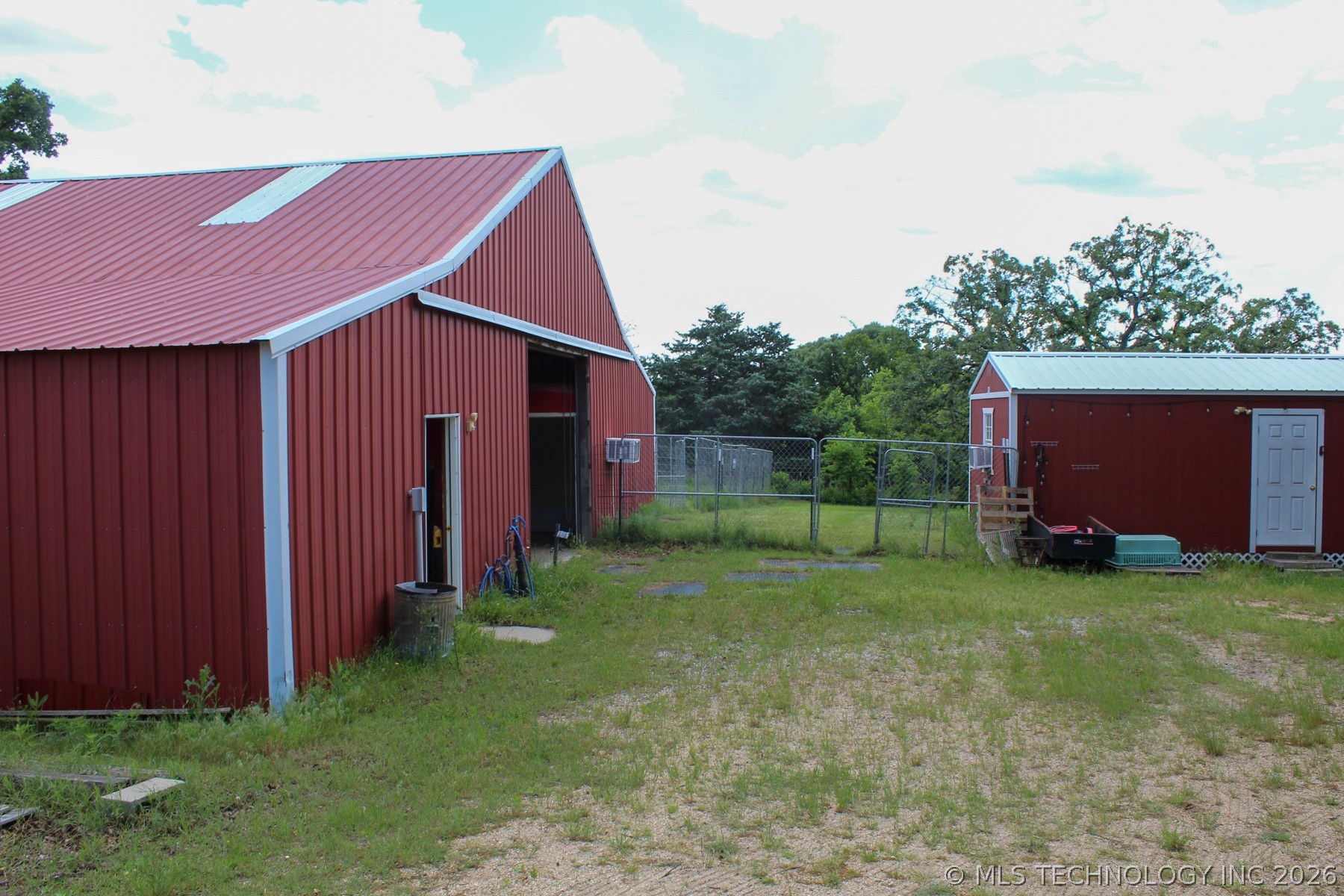 13248 North 3540th Road Maud, OK 74854 - Photo 90 of 98 Red metal barn with a gambrel roof featuring a large open entrance