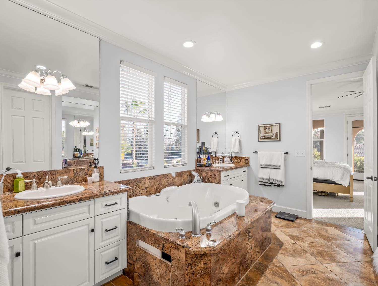1152 Lester Avenue Clovis, CA 93619 - Photo 11 of 68 a spacious bathroom with a granite countertop tub sink and mirror