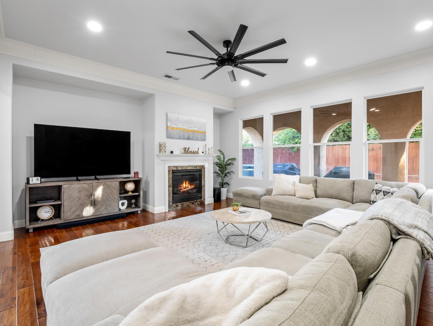 1152 Lester Avenue Clovis, CA 93619 - Photo 37 of 68 a living room with furniture a large window and a flat screen tv