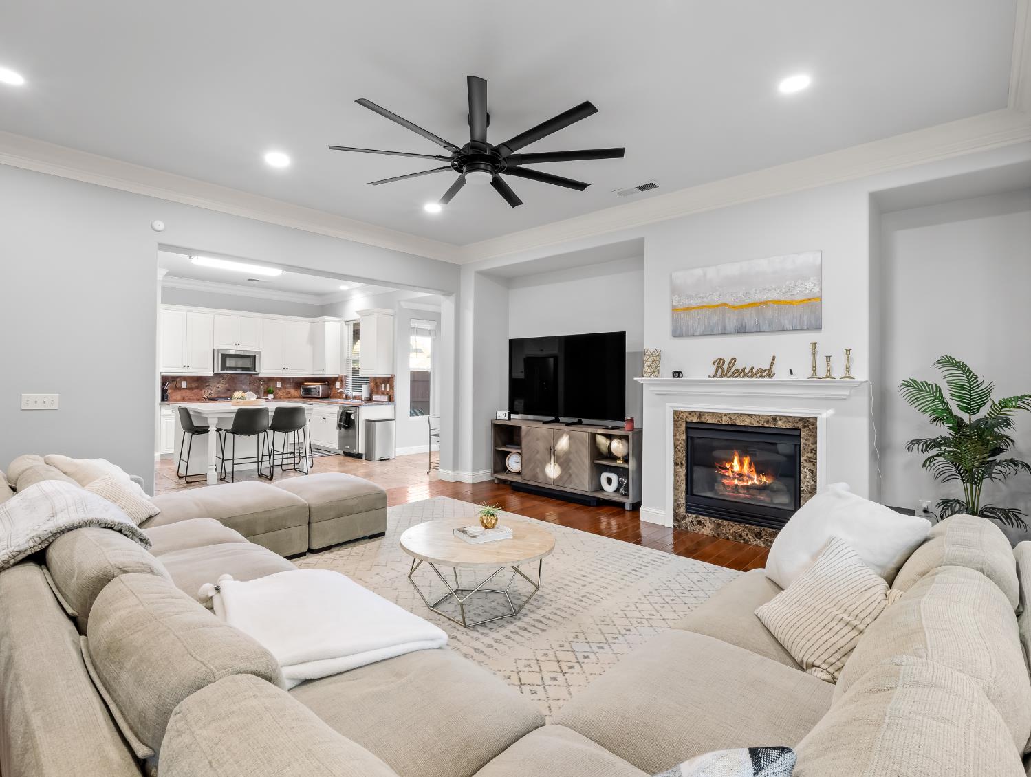 1152 Lester Avenue Clovis, CA 93619 - Photo 38 of 68 a living room with furniture a flat screen tv and a fireplace