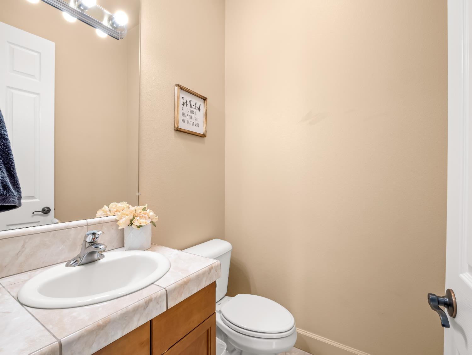1152 Lester Avenue Clovis, CA 93619 - Photo 4 of 68 a bathroom with a sink a toilet and mirror