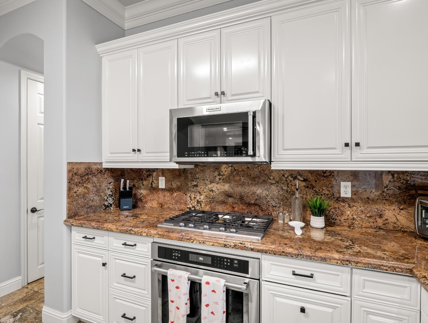 1152 Lester Avenue Clovis, CA 93619 - Photo 42 of 68 a kitchen with granite countertop white cabinets and stainless steel appliances