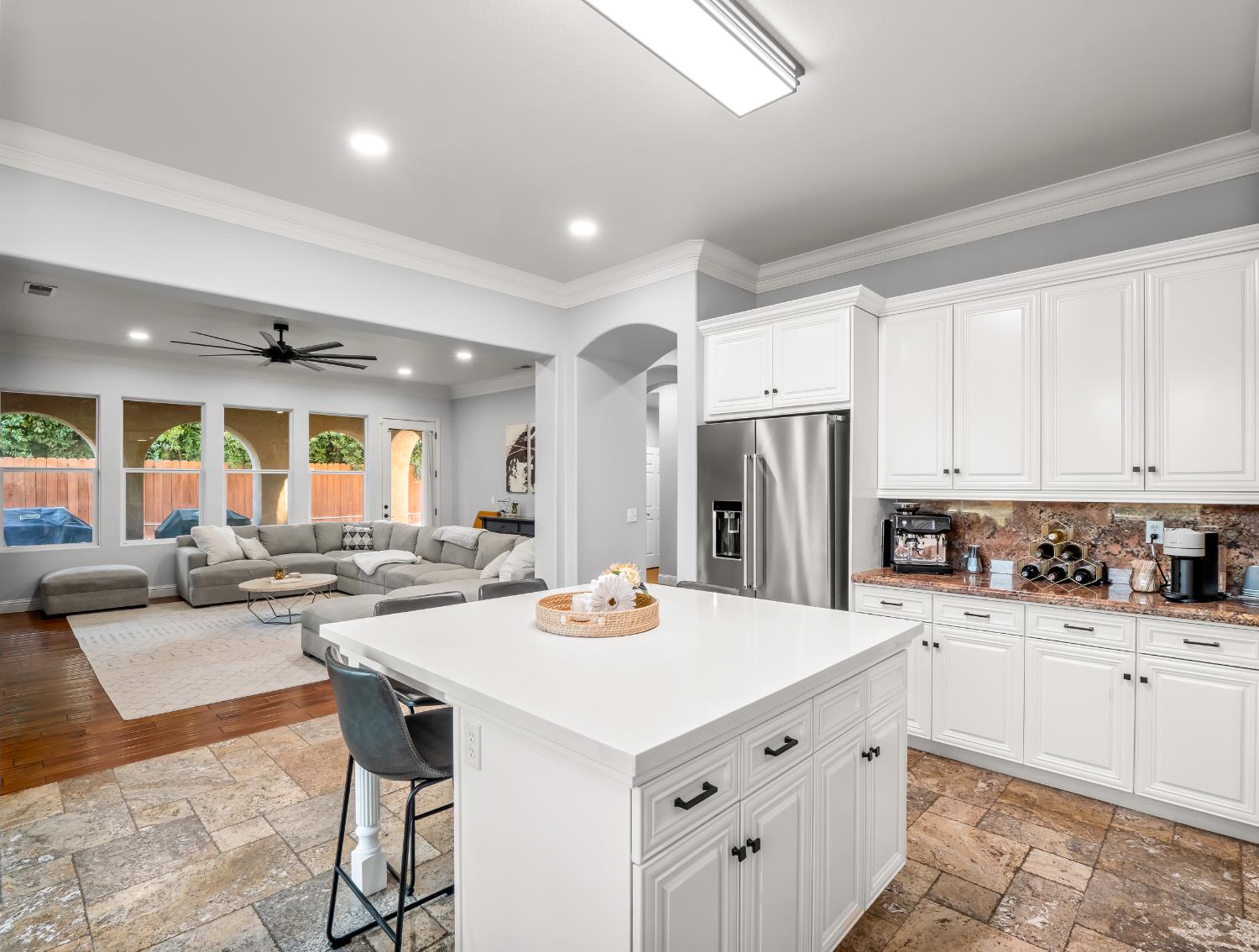 1152 Lester Avenue Clovis, CA 93619 - Photo 44 of 68 a kitchen with stainless steel appliances kitchen island granite countertop a sink refrigerator and cabinets