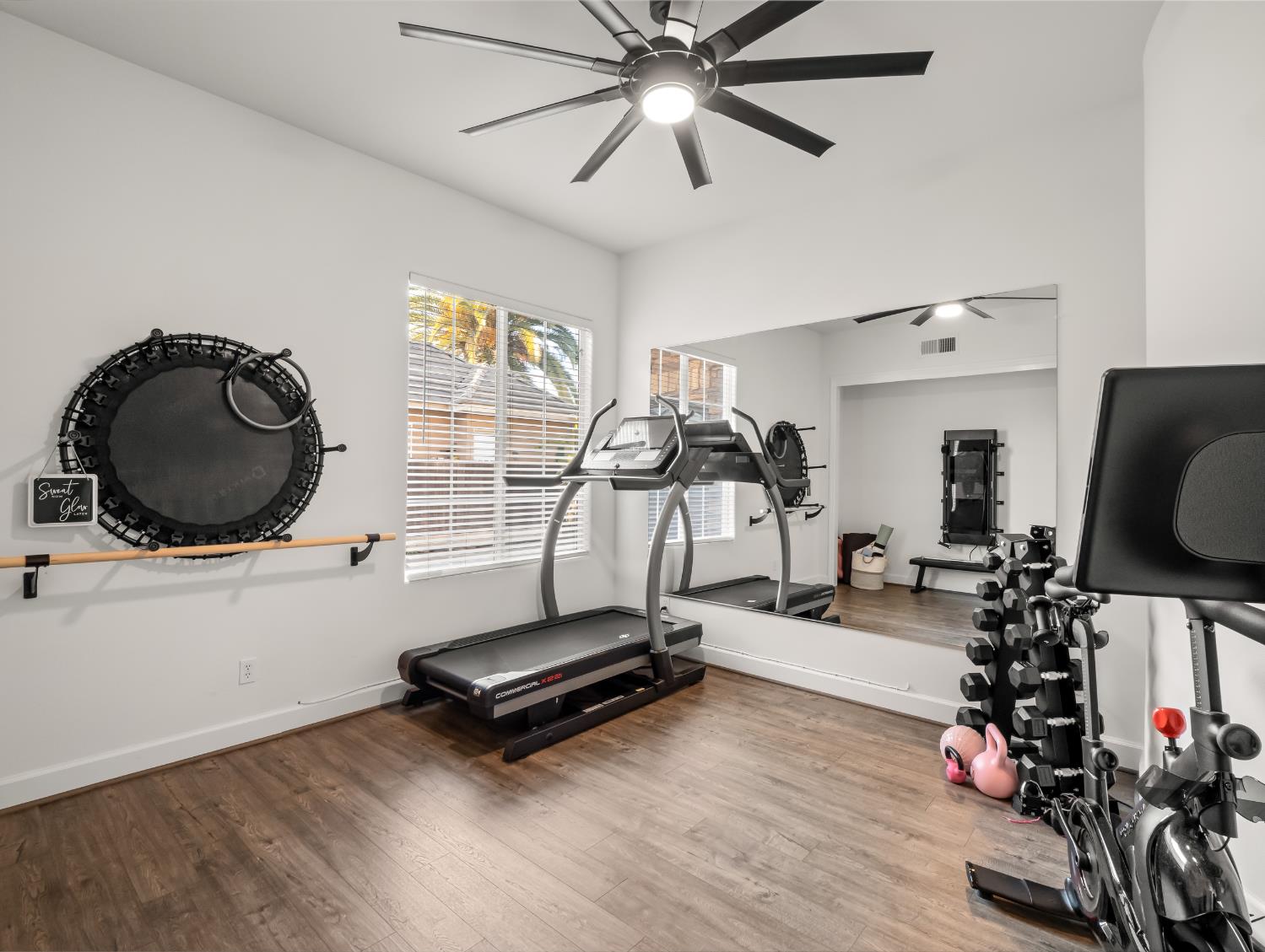 1152 Lester Avenue Clovis, CA 93619 - Photo 46 of 68 a room with gym equipment and wooden floor