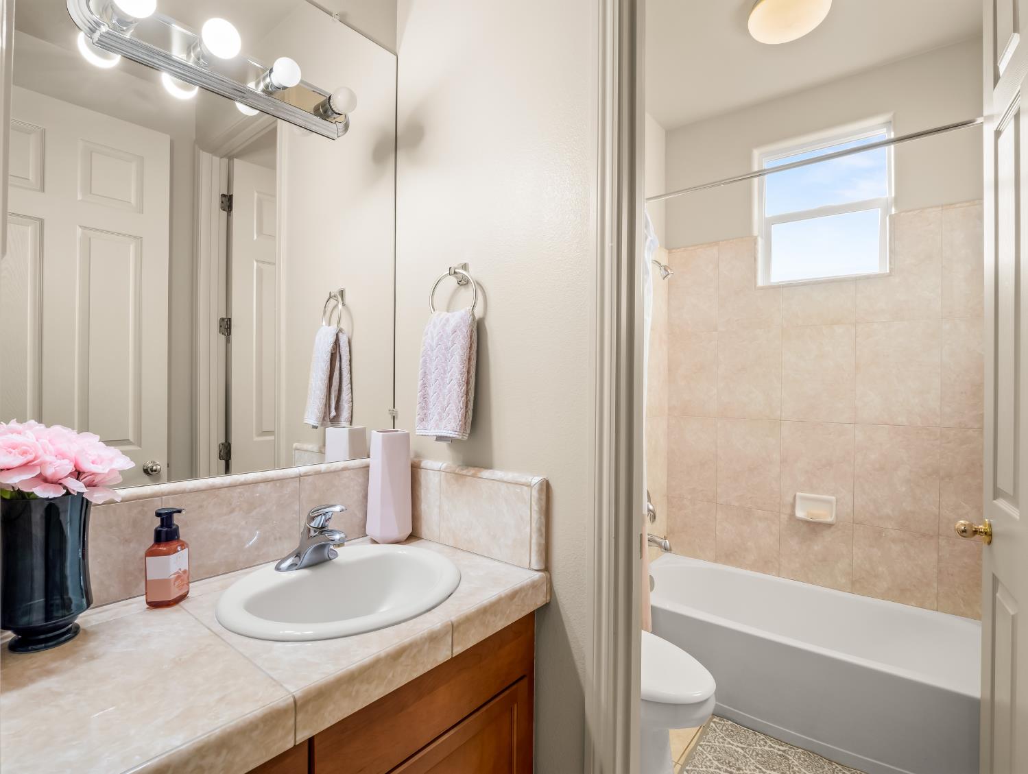 1152 Lester Avenue Clovis, CA 93619 - Photo 63 of 68 a bathroom with a sink vanity tub and shower