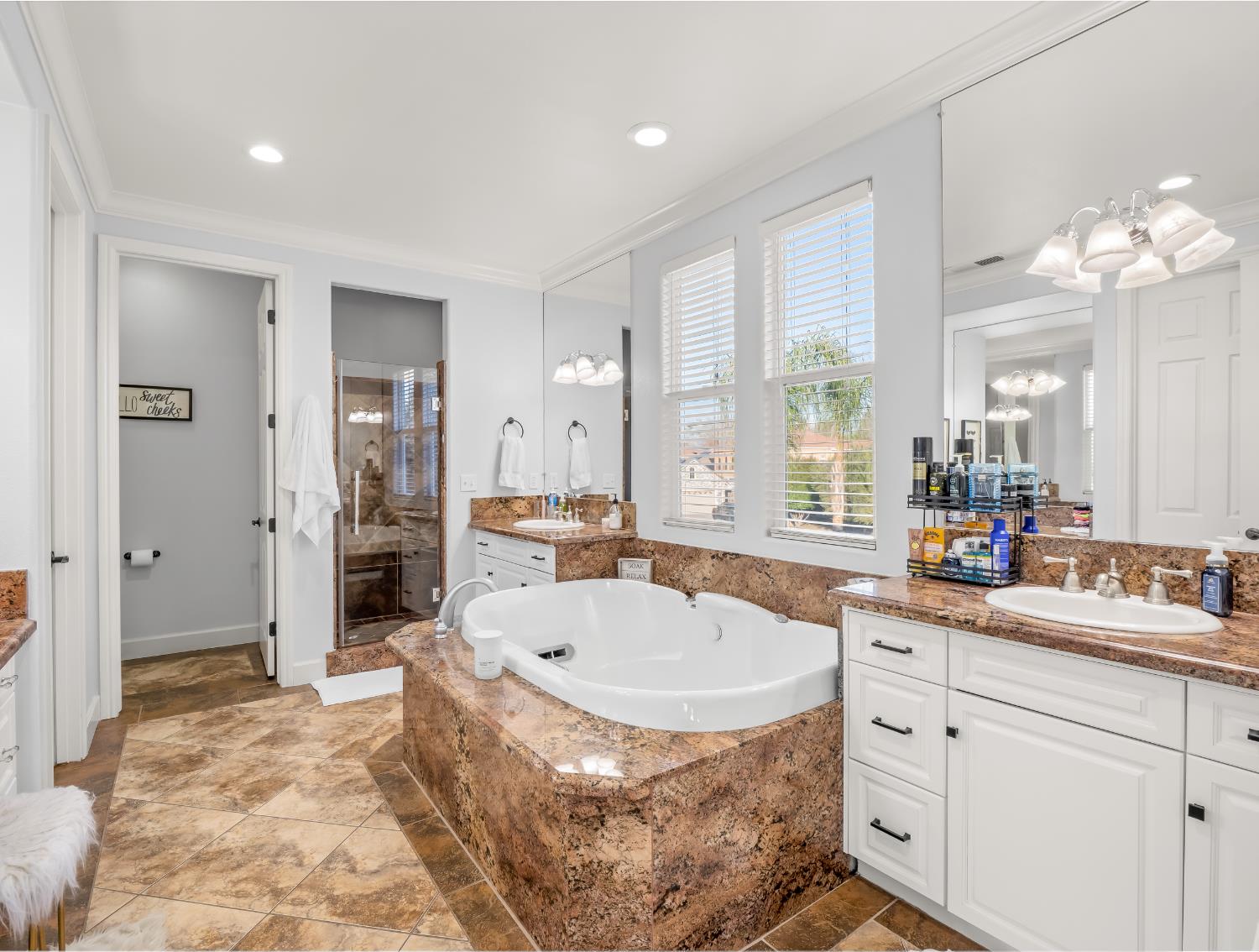 1152 Lester Avenue Clovis, CA 93619 - Photo 9 of 68 a spacious bathroom with a tub sink and mirror