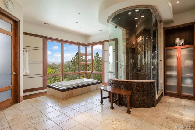a bathroom with a granite countertop sink a large mirror and a light fixture