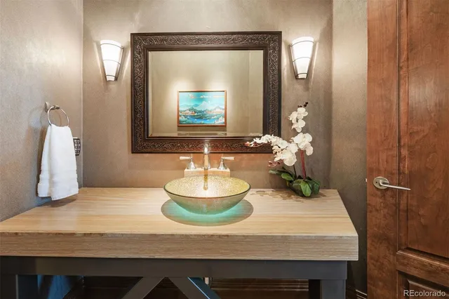 an aerial view of a house with balcony and trees al around