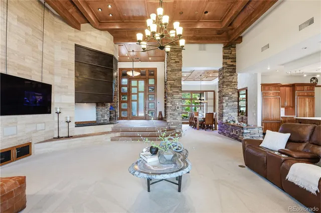 a view of a dining room with furniture a chandelier and window