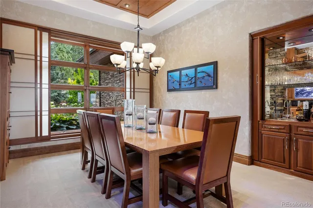 a view of a dining room with furniture large windows and wooden floor
