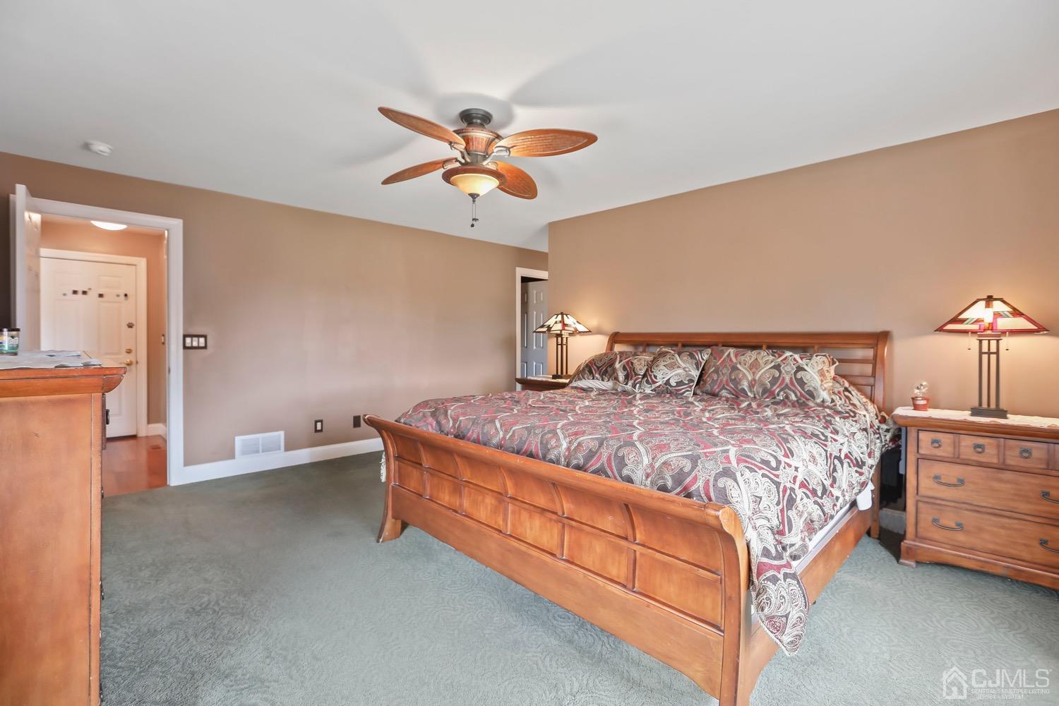 39 Loveman Road Cream Ridge, NJ 08514 - Photo 32 of 73 a bed sitting in a room next to a lamp