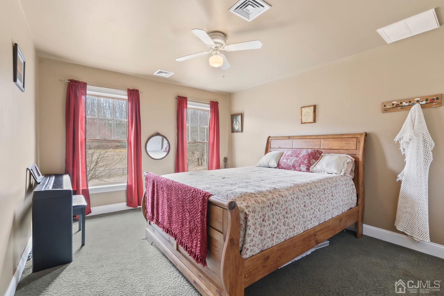 39 Loveman Road Cream Ridge, NJ 08514 - Photo 39 of 73 a bed room with a bed and a chandelier