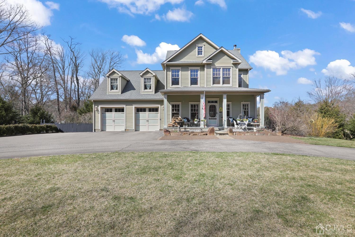 39 Loveman Road Cream Ridge, NJ 08514 - Photo 4 of 73 a view of a white house with large windows and a yard