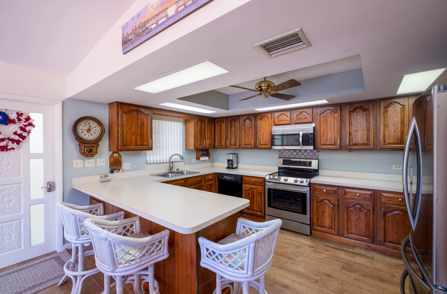 205 Sunset Boulevard Key Largo, FL 33037 - Photo 11 of 42 a kitchen with a stove a refrigerator and a dining table