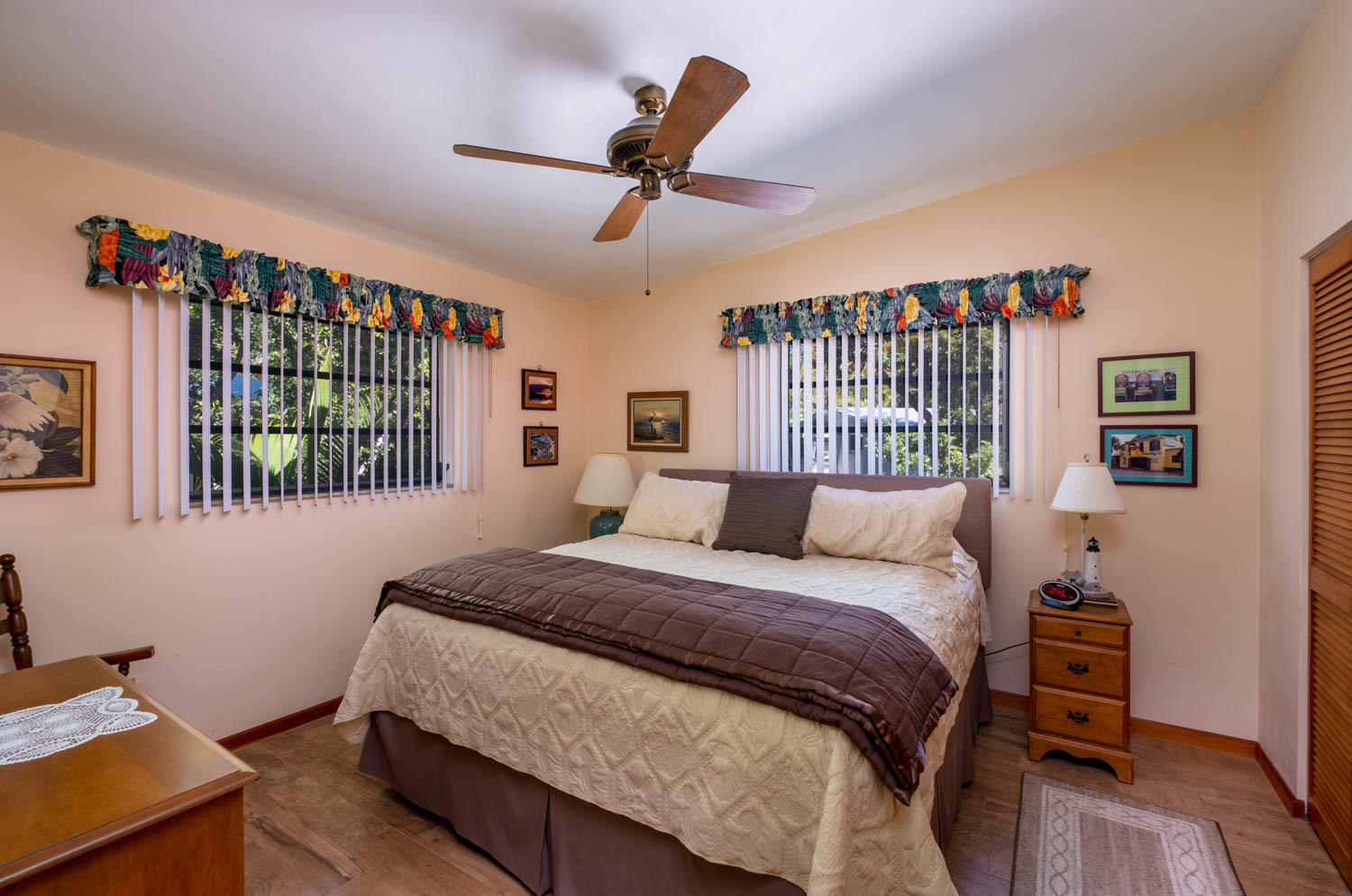 205 Sunset Boulevard Key Largo, FL 33037 - Photo 19 of 42 a bedroom with a bed a dresser and a large window