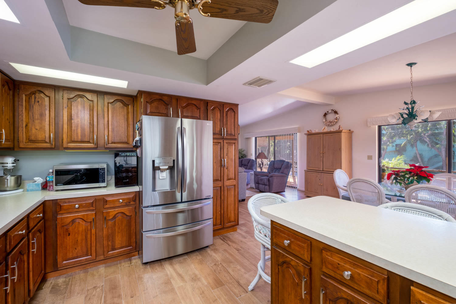 205 Sunset Boulevard Key Largo, FL 33037 - Photo 10 of 42 a kitchen with a refrigerator sink and wooden cabinets