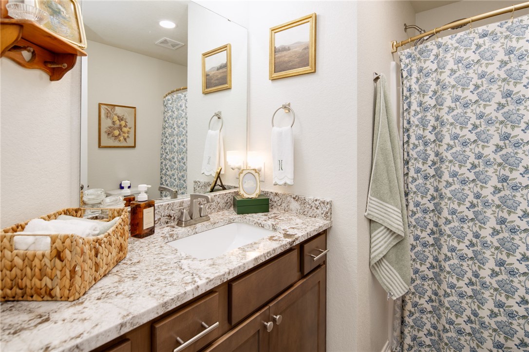 2799 Messenger Way Bryan, TX 77803 - Photo 11 of 15 a bathroom with a granite countertop sink and a mirror