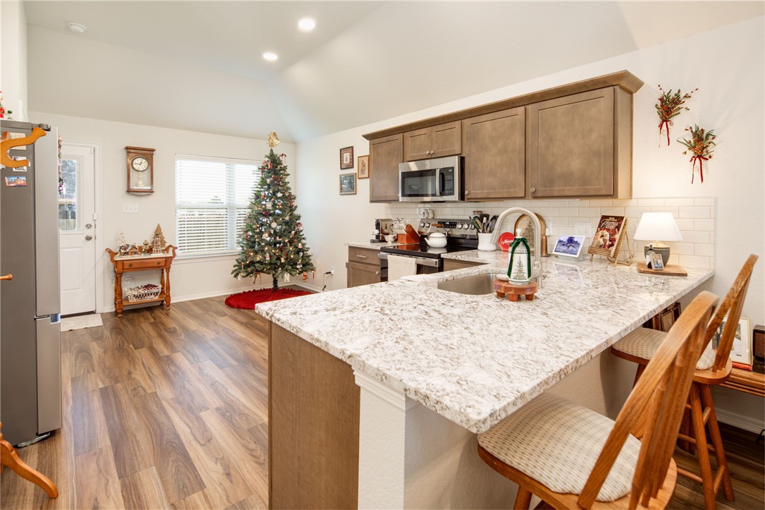 2799 Messenger Way Bryan, TX 77803 - Photo 6 of 15 a kitchen with granite countertop a sink and cabinets