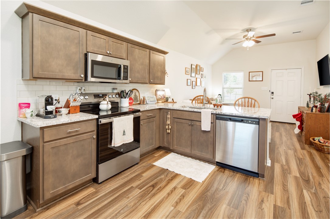 2799 Messenger Way Bryan, TX 77803 - Photo 7 of 15 a kitchen with stainless steel appliances a sink dishwasher stove refrigerator and cabinets