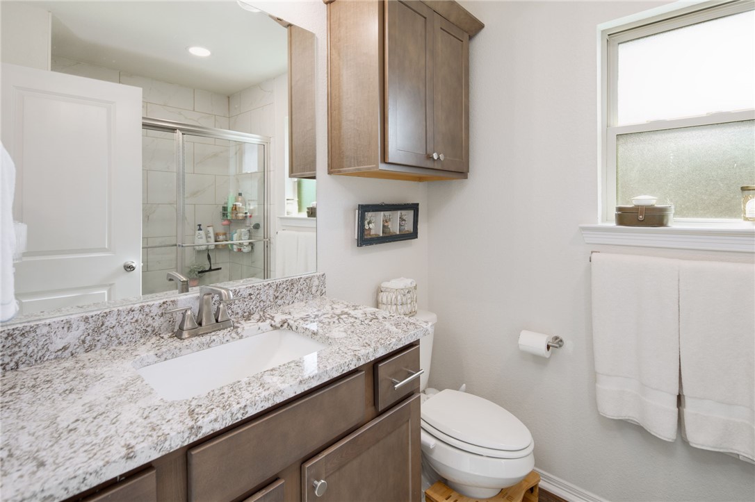 2799 Messenger Way Bryan, TX 77803 - Photo 9 of 15 a bathroom with a granite countertop sink a toilet and a mirror
