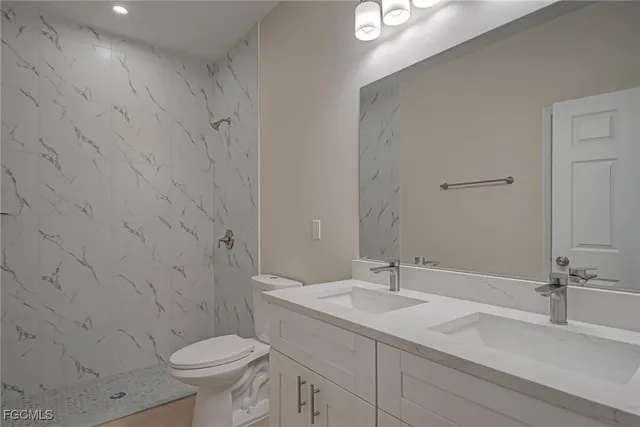 a bathroom with a sink toilet and vanity