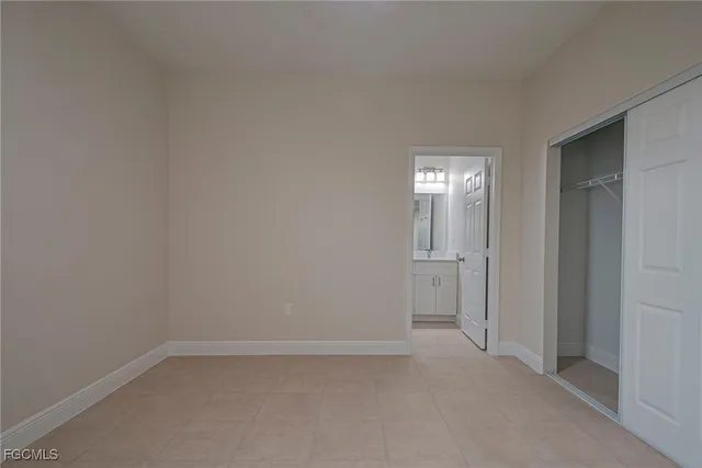 a view of an empty room and closet area