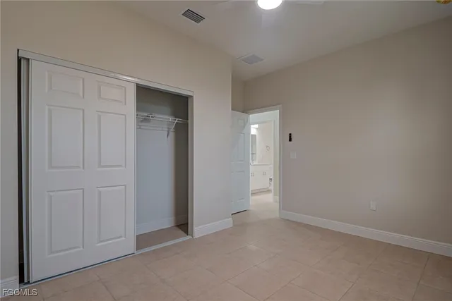 an empty room with closet area