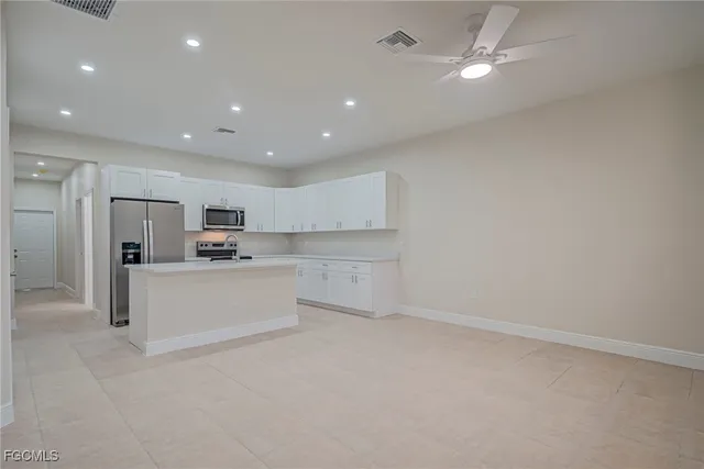 a view of kitchen with white cabinets