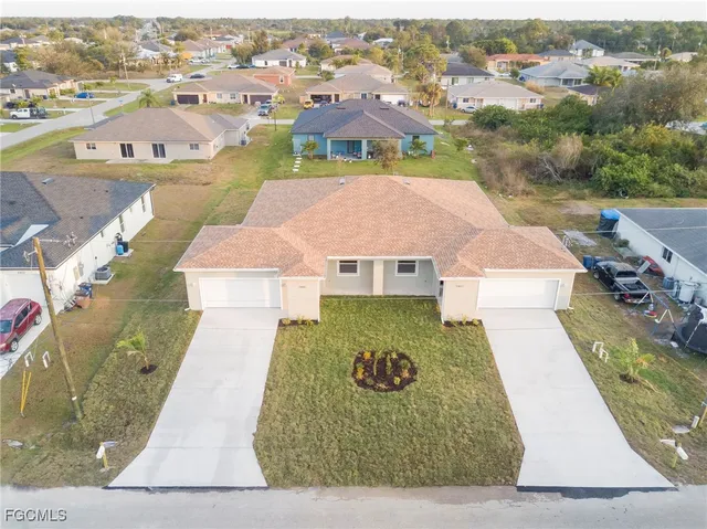an aerial view of a house with a yard