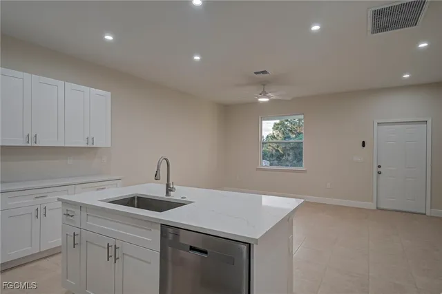 a kitchen with a sink and chandelier