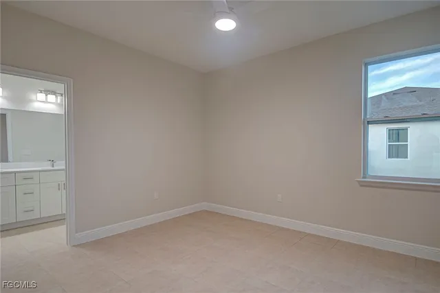 an empty room with a window and a bathroom