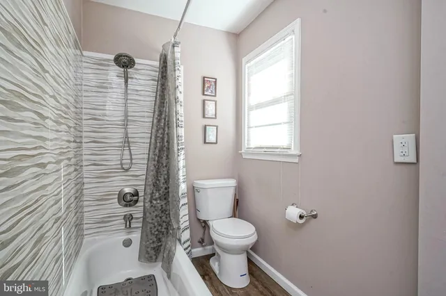 a bathroom with a toilet a sink and shower