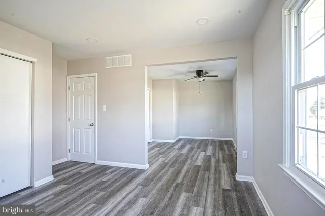 wooden floor in an empty room with a window