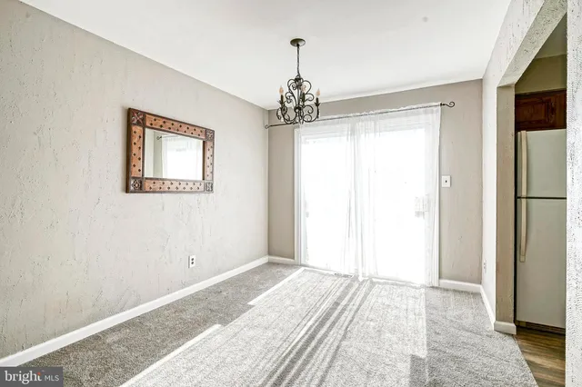 a view of a bedroom with a bed and wooden floor