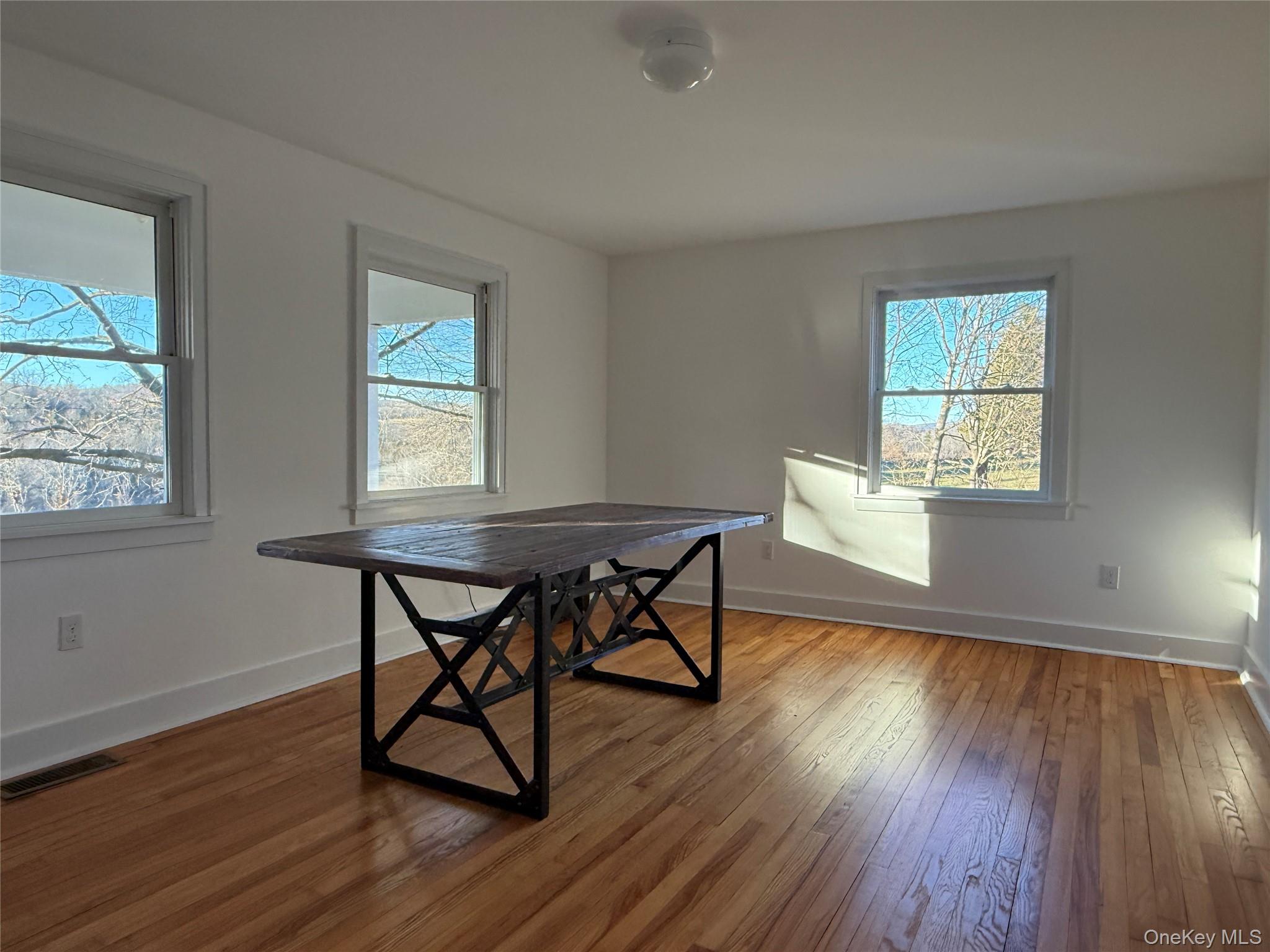 156 Sharon Station Road Amenia, NY 12501 - Photo 9 of 17 a workspace with wooden floor and a window