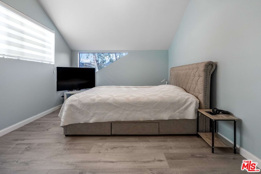 2015 Corral Canyon Road Malibu, CA 90265 - Photo 15 of 24 a bedroom with a bed and a night stand