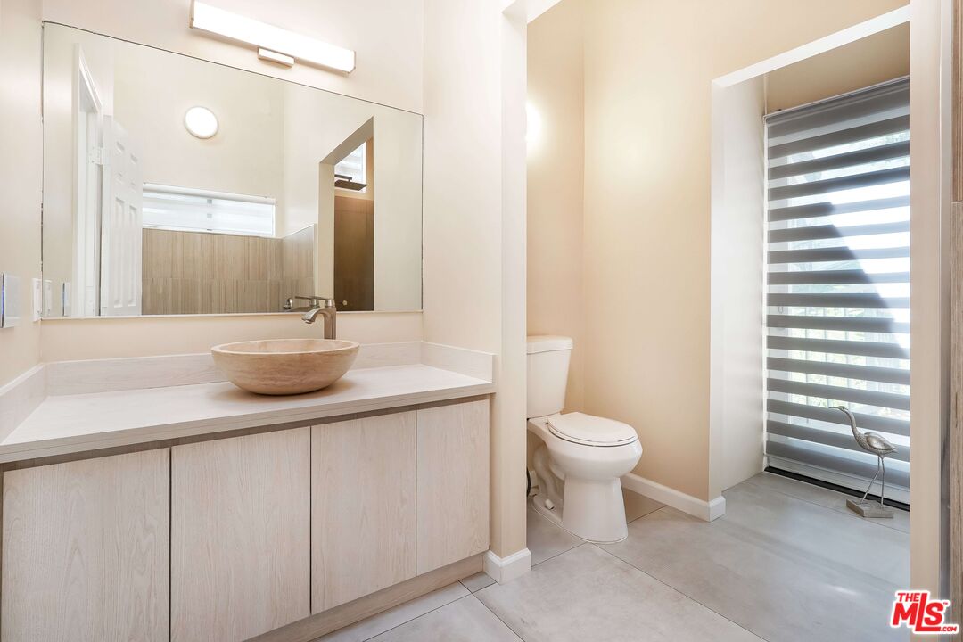 2015 Corral Canyon Road Malibu, CA 90265 - Photo 17 of 24 a bathroom with a sink a toilet and a mirror