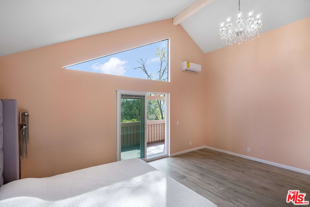 2015 Corral Canyon Road Malibu, CA 90265 - Photo 10 of 24 a view of a big room with wooden floor and chandelier