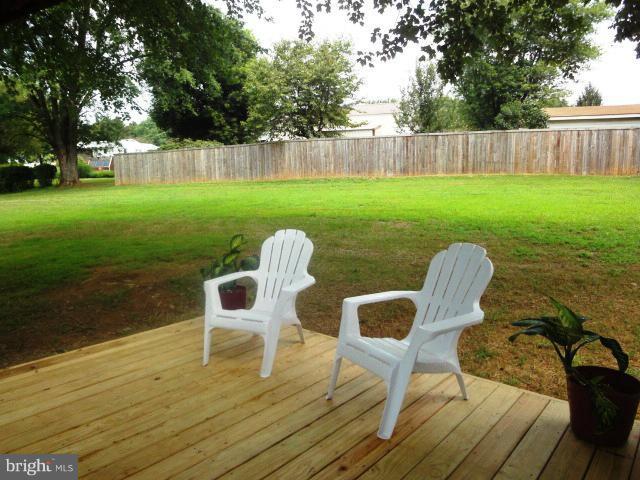 4902 Upper Beckleysville Road Hampstead, MD 21074 - Photo 14 of 25 a view of a chair and table on the wooden deck