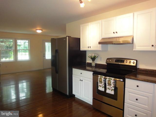 4902 Upper Beckleysville Road Hampstead, MD 21074 - Photo 8 of 25 a kitchen with granite countertop white cabinets and refrigerator