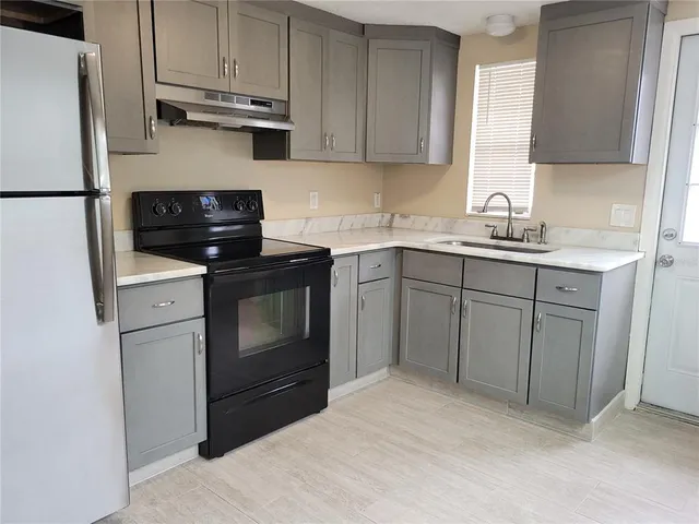 a kitchen with appliances cabinets and a sink