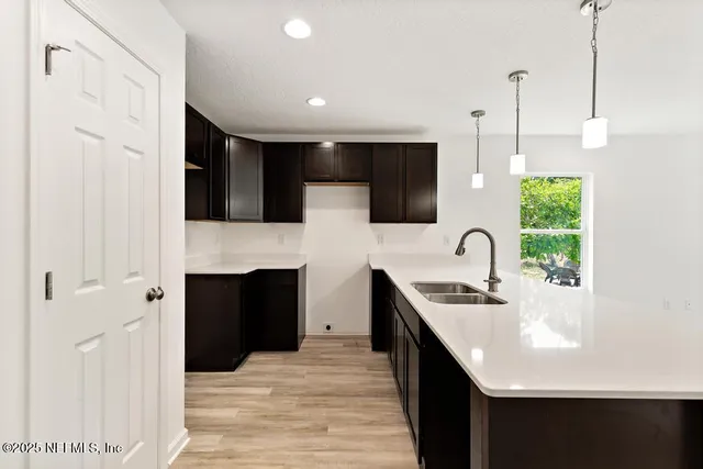 a view of kitchen with stainless steel appliances kitchen island sink stove and refrigerator