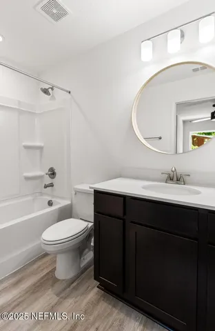 a bathroom with a sink toilet a mirror and shower