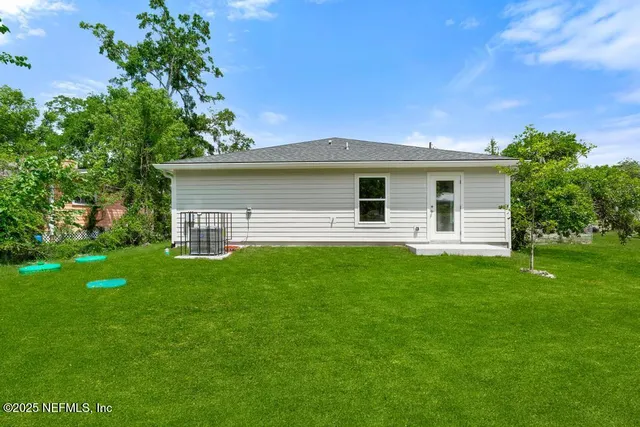 a front view of house with yard and green space
