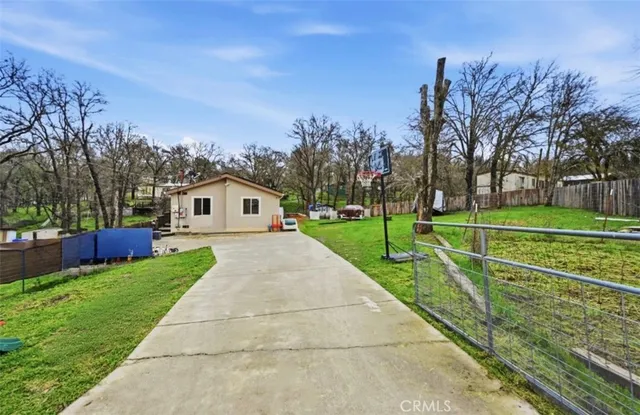 a front view of a house with a yard and trees